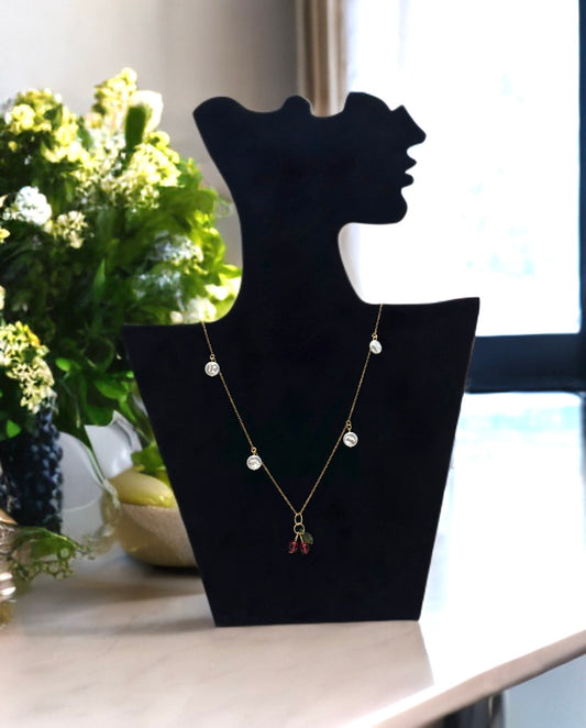 Cherry Bliss necklace in 18k gold-plated stainless steel on a stand