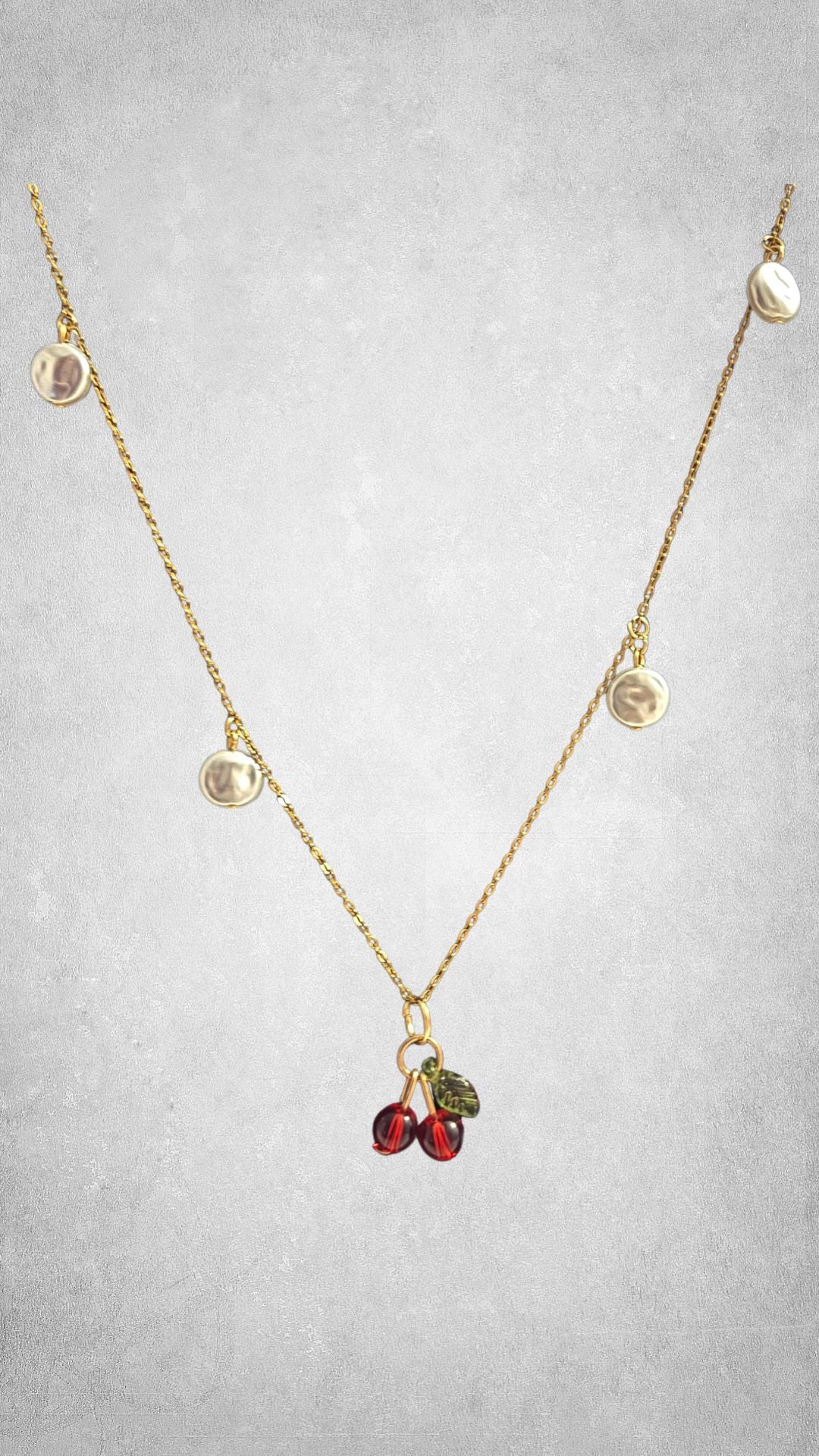 Cherry bliss necklace in the pack duo of gold close up on white backround