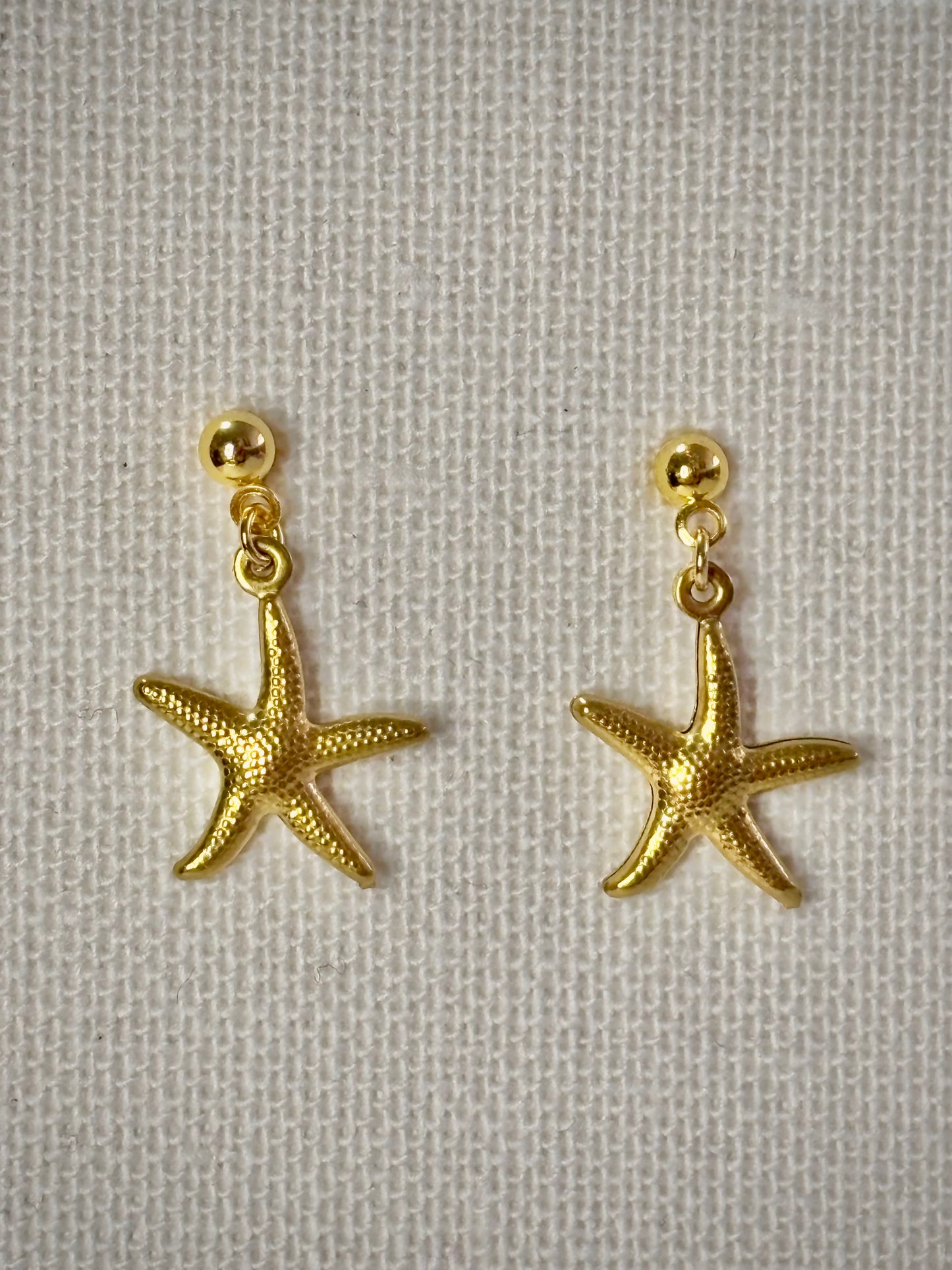 Golden sea stars gold stainless steel earrings close up