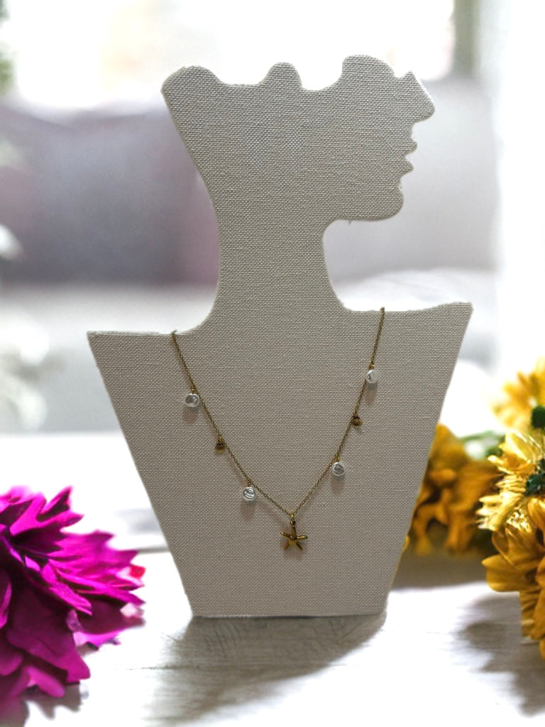 the Ocean Breeze stainless steel gold necklace – ideal for summer looks - on a stand