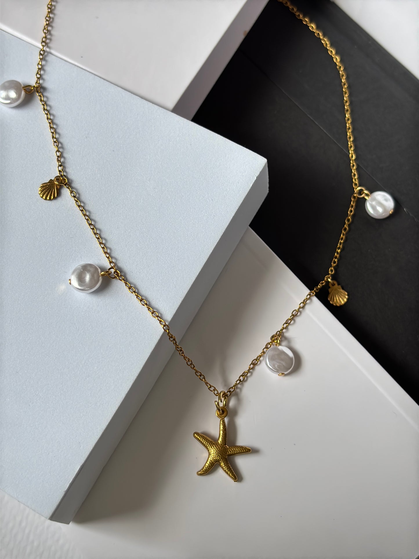the Ocean Breeze stainless steel necklace – ideal for summer looks on a flat surface black and white