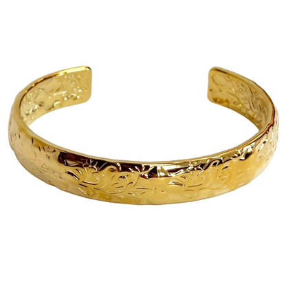 Gold bracelet with floral patterns graving on a white background