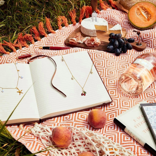 Pack duo of gold necklace outside on a book