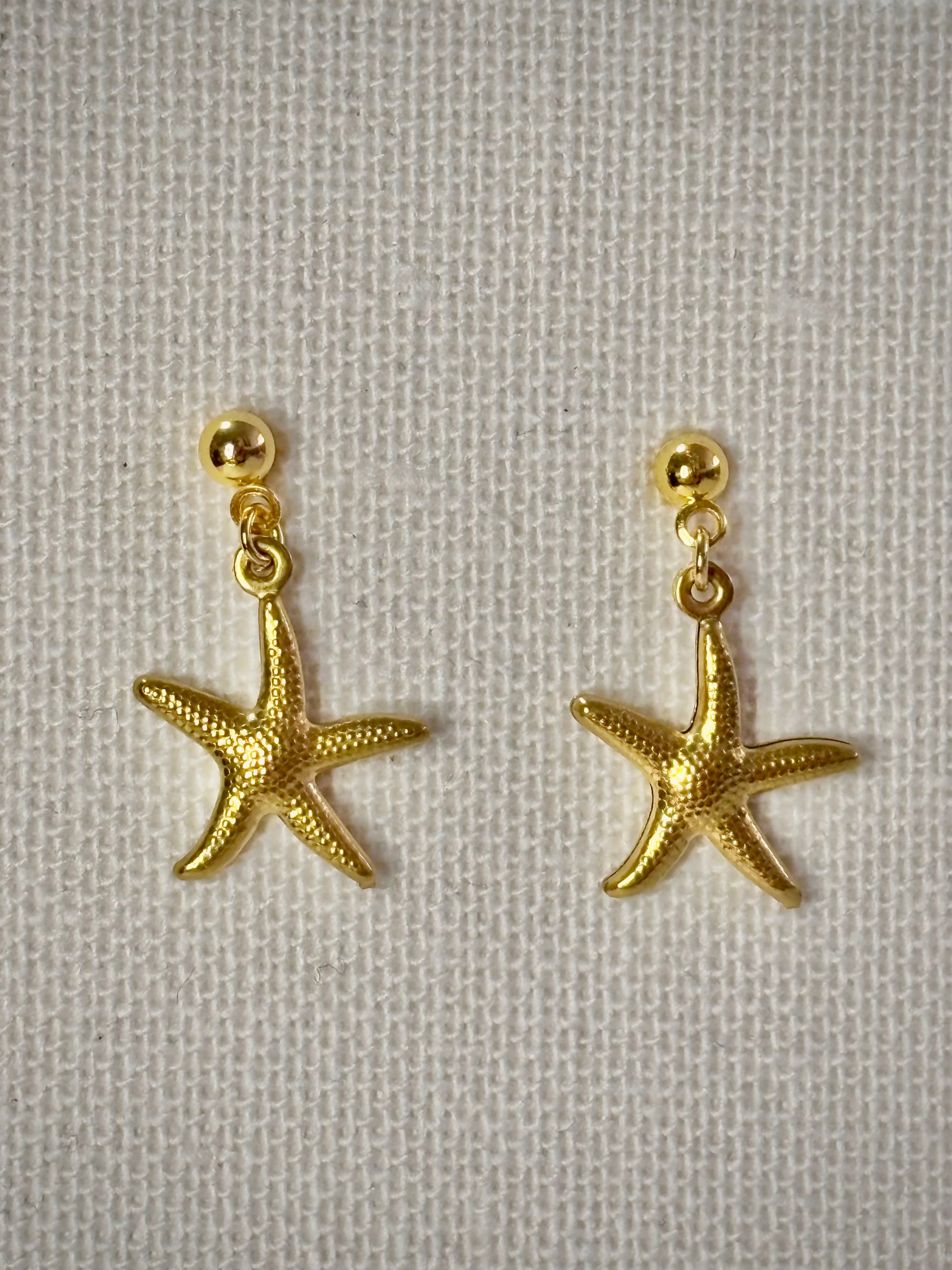 Golden sea stars gold stainless steel earrings close up